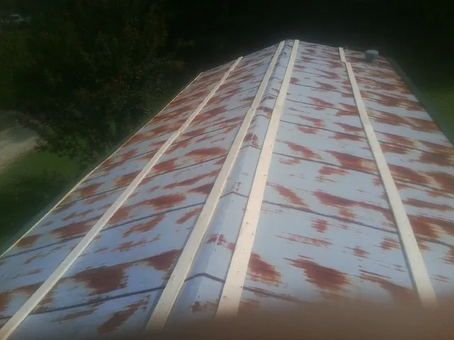 Rusted metal roof panels with new wood purlins before replacement — Storm Damage Roof Repair in Fork Union by Roofing Brothers