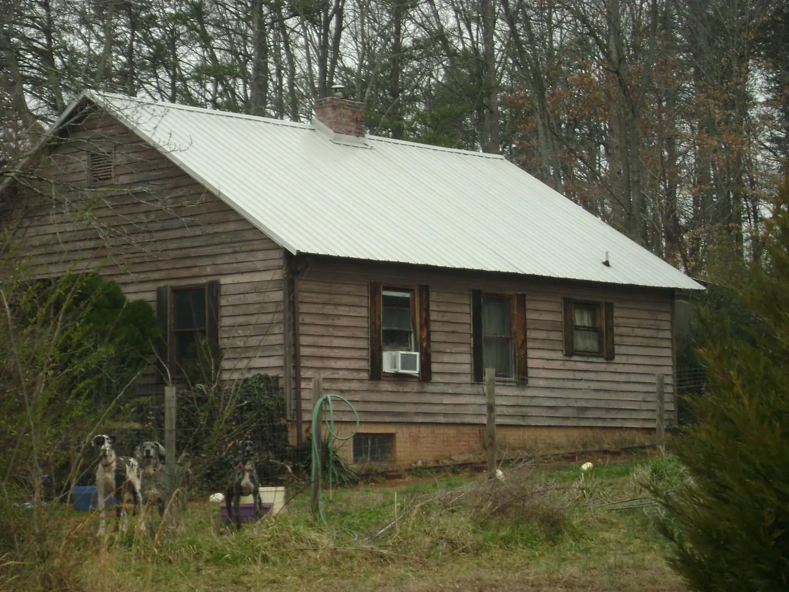 White metal roof on an old wood sided farmhouse, from a Metal Roof Installation job in Fork Union